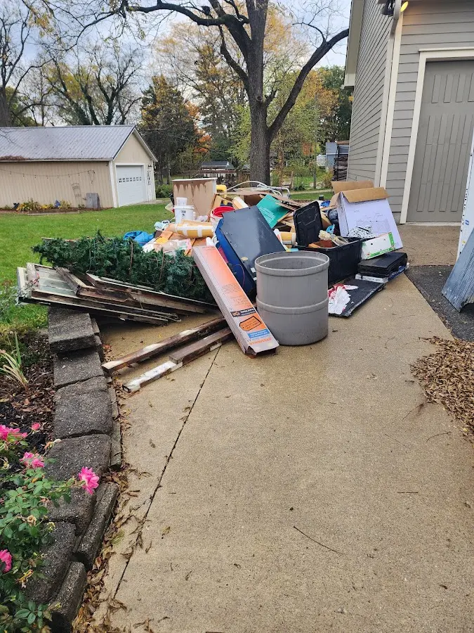 Dumpster being loaded with debris for Roofing Dumpster Rental in Gladewater